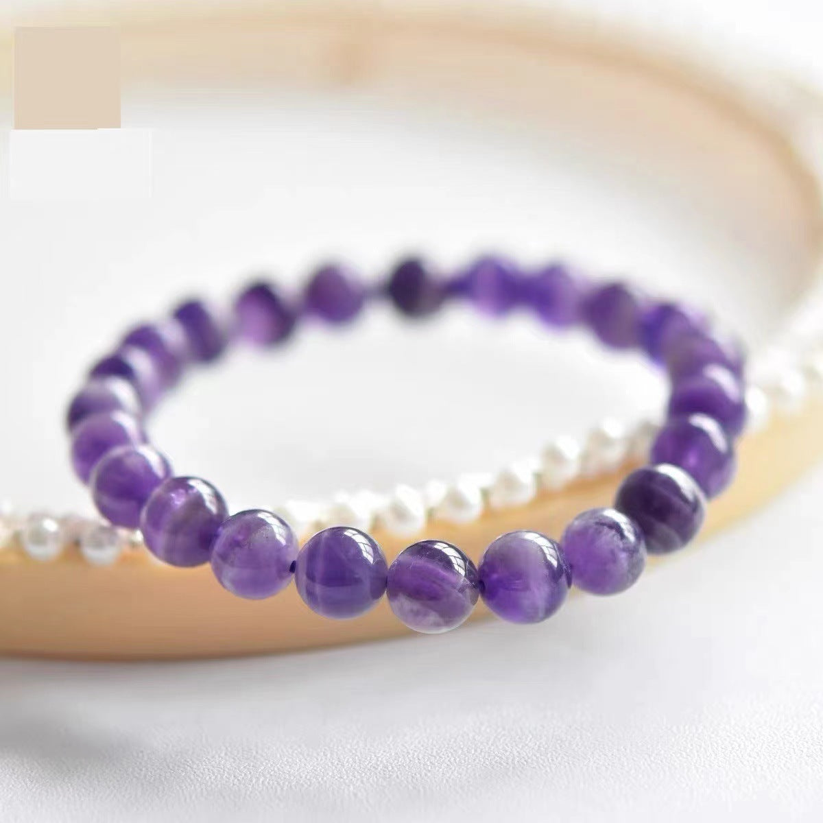 Amethyst Bracelet on wooden ring.