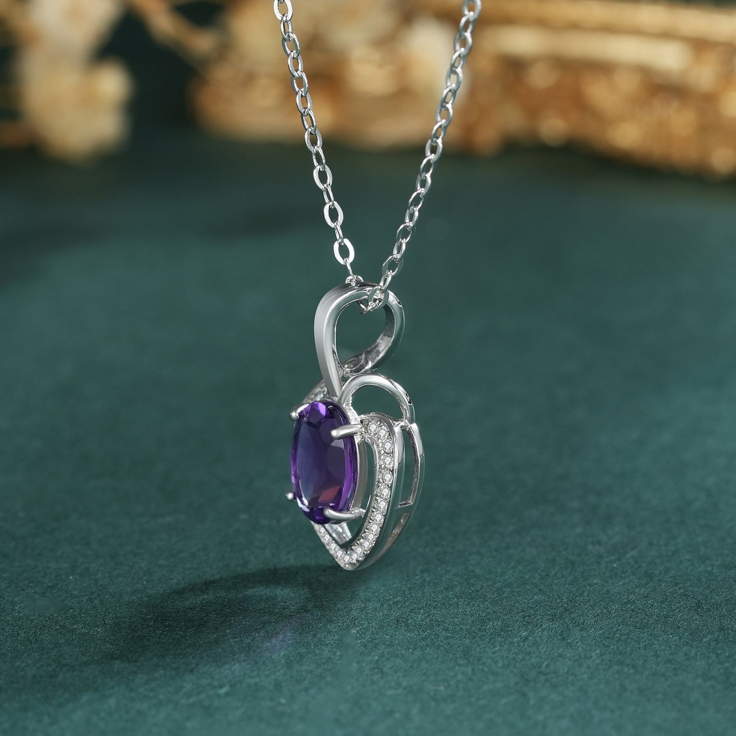 amethyst heart necklace with teal background