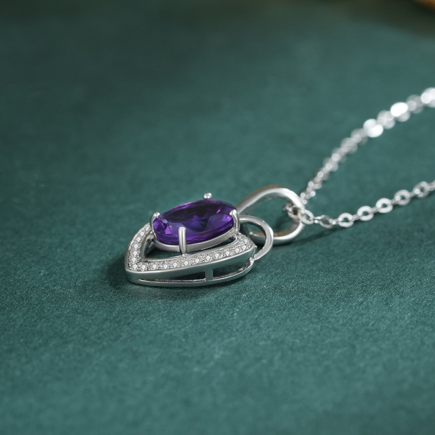 amethyst heart necklace with teal background