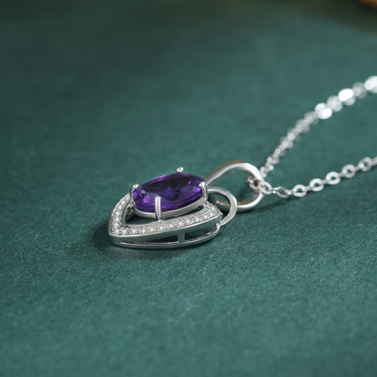 amethyst heart necklace with teal background