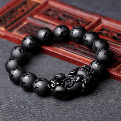 Black Jade Bracelet With Lucky Mantra near the wooden item