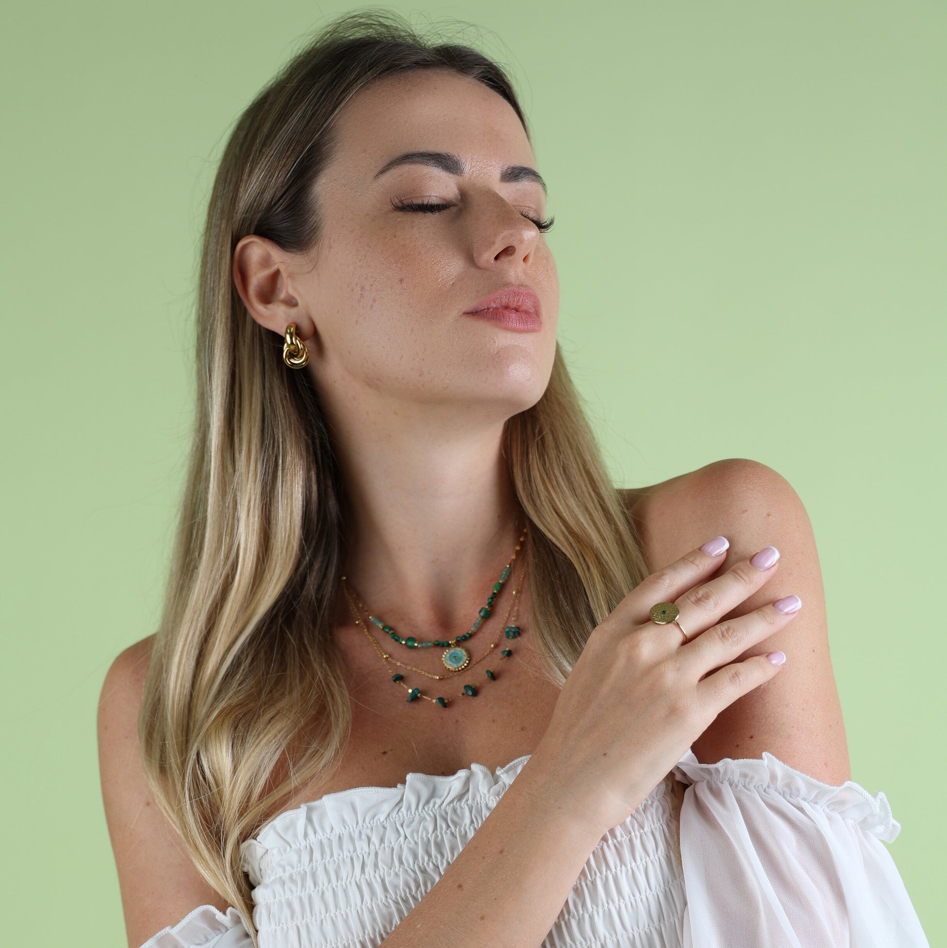 green necklace on woman