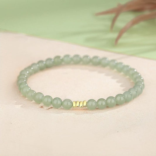 Green Jade Bracelet on Grey background.