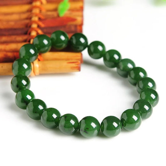 Jade Beaded Bracelet on the white and wooden bacground