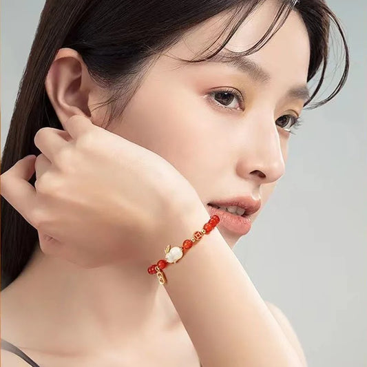Red Jade Bracelet With Lucky Charm on the hand of beautiful girl